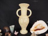 a white vase sitting on a table next to other items
