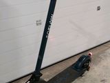 a scooter that is parked in front of a garage