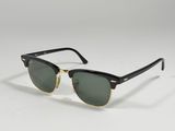 a pair of black and gold sunglasses on a white background