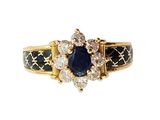 a close up of a gold ring with a sapphire and diamonds