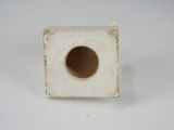 a small square white object with a hole in it