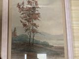 framed painting of a tree on a hill with a river in the foreground