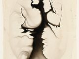 a black and white photo of a person breaking a hole in a wall