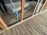 a person standing outside of a glass door with a shopping cart