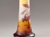 a glass vase with a design on it on a table