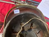 a metal helmet with a rope around it on a table