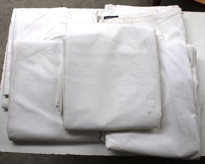 a lot of white shirts and pants on a table