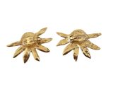 a pair of gold tone flower earrings on a white background