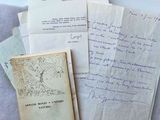 some old papers are piled on top of each other on a table