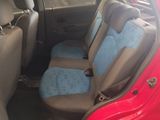 a red car with blue seat covers in the back of it