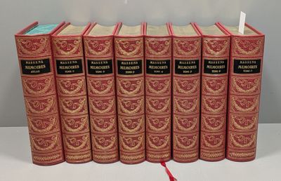 six livres rouges sont alignés sur une surface blanche