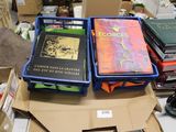 several books are stacked on top of each other on a table