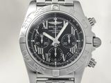 a close up of a stainless steel watch with a black dial