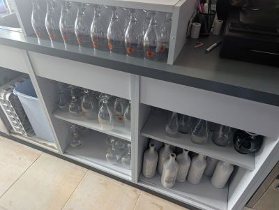 a counter with a bunch of empty bottles on it