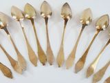 a lot of spoons sitting in a circle on a table