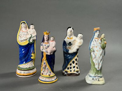 several figurines of different sizes and colors are displayed on a gray surface