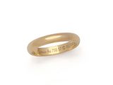 a close up of a gold ring on a white background