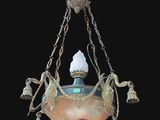 a light hanging from a chandelier in a dark room