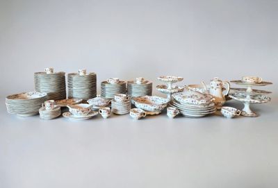 a lot of plates and cups that are sitting on a table