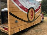 a food truck that is parked in the grass