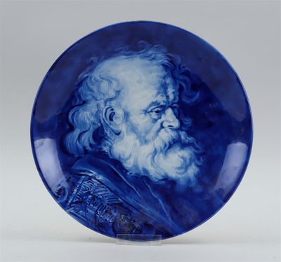 a blue and white plate with an image of a bearded man