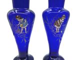 two blue vases with a picture of a woman and a dog on them