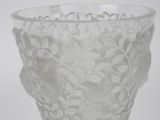 a clear glass vase with a floral design on it