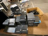 a lot of electronic equipment on a table in a warehouse