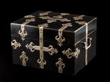 a black box with gold decorations on it on a black background