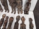 some very old wooden figurines sitting on top of a white table