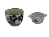a cup and saucer sitting next to each other on a white surface