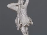 a statue of a man holding a sword on a table