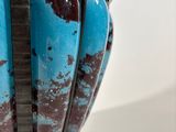 a vase that has a blue and brown design on it