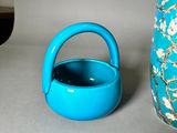 a blue vase and a blue teapot sitting next to each other