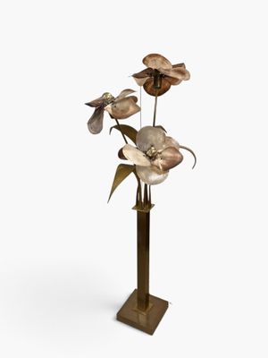 an image of a vase with flowers on a stand on a white background