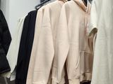 many clothes hanging on a rack in a room
