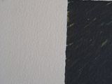 a black piece of paper on the wall next to a black piece of paper