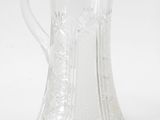 two glass pitchers sitting next to each other on a table
