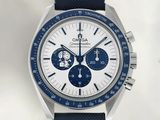 a close up of a watch with a blue strap on a white background