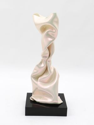 statue of a woman in a flowing white dress on a black base