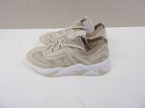 beige sneakers with white soles on a white surface