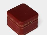 a small red box that is sitting on a white surface