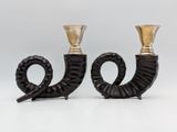 pair of black and gold candlesticks sitting on top of each other