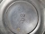 a close up of a silver plate with a number on it