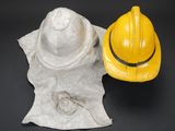 a yellow hard hat and a yellow hard hat on a piece of paper