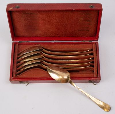 silverware in a red case with a spoon and spoon rest