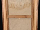 an old picture of a wooden frame with a window in it