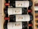 many bottles of wine sitting in a wooden box