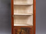an antique wooden bookcase with a painting on the front