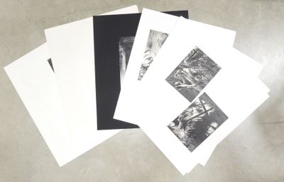 several black and white photographs of people on a table